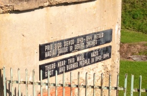 sign by wall where they mass murdered victims